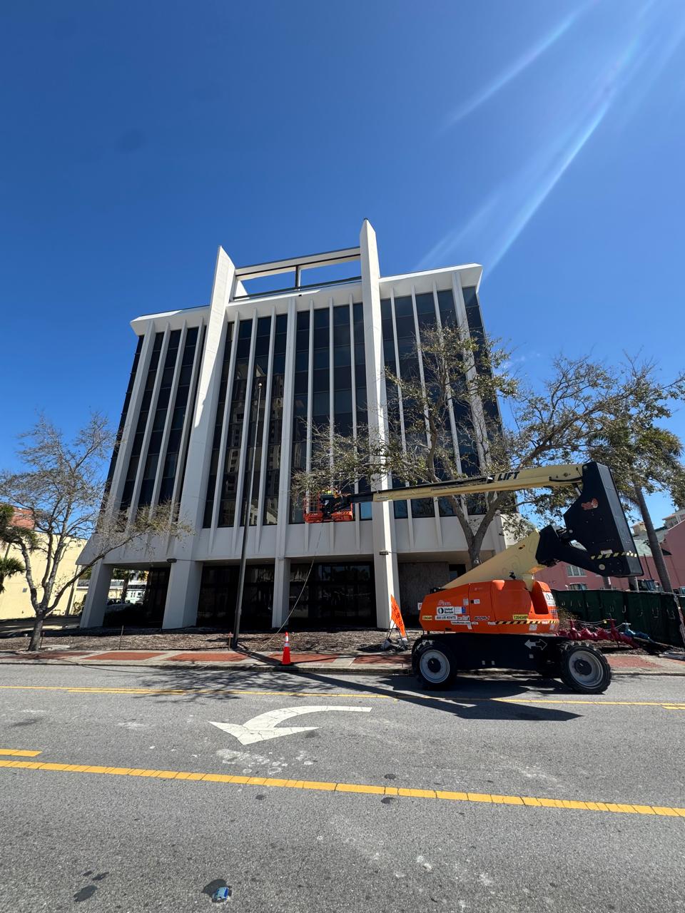 BlueSky boom lift staged at a commercial high-rise during scheduled facade work