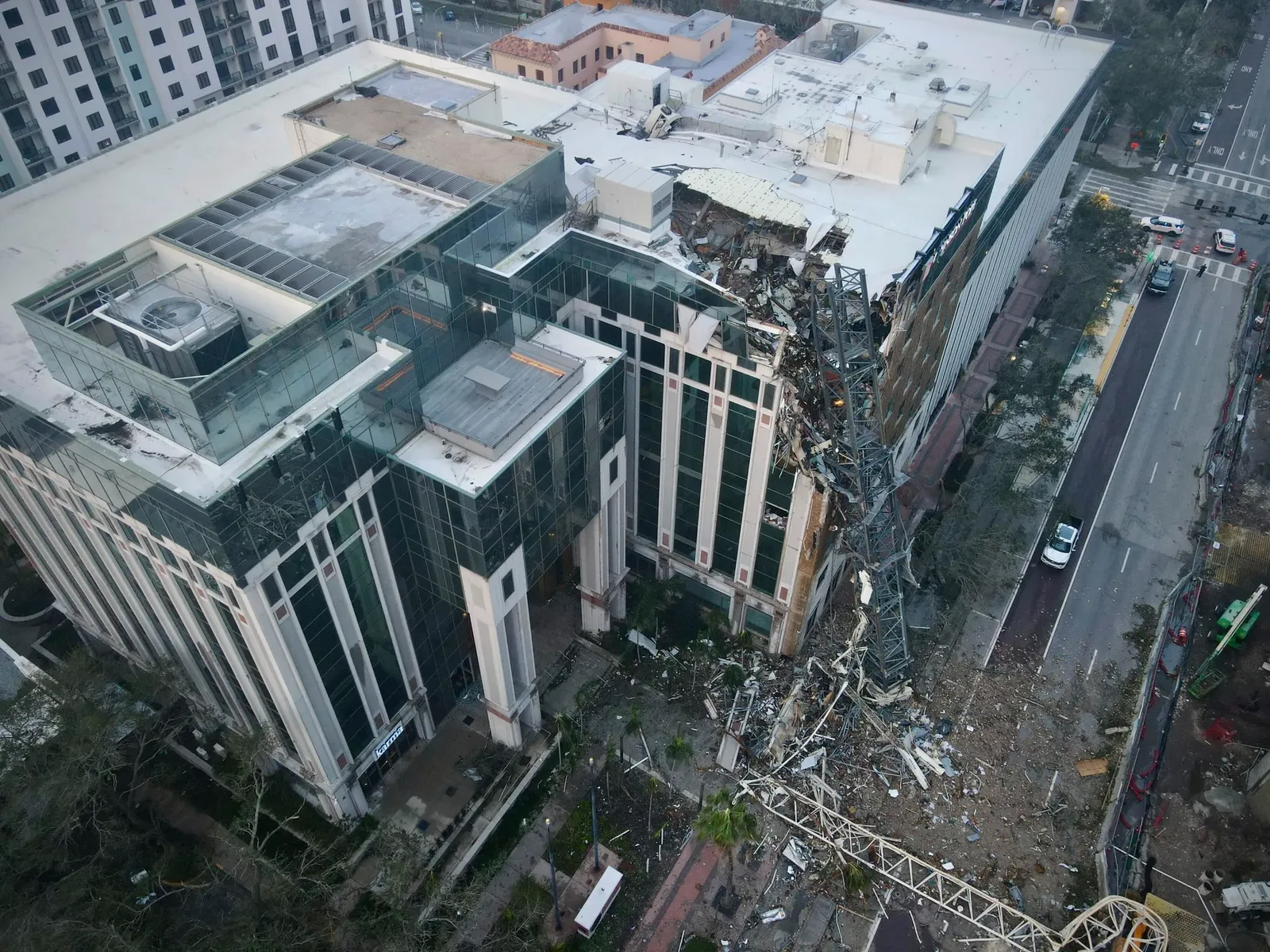 Top-down aerial of building with crane debris on the side