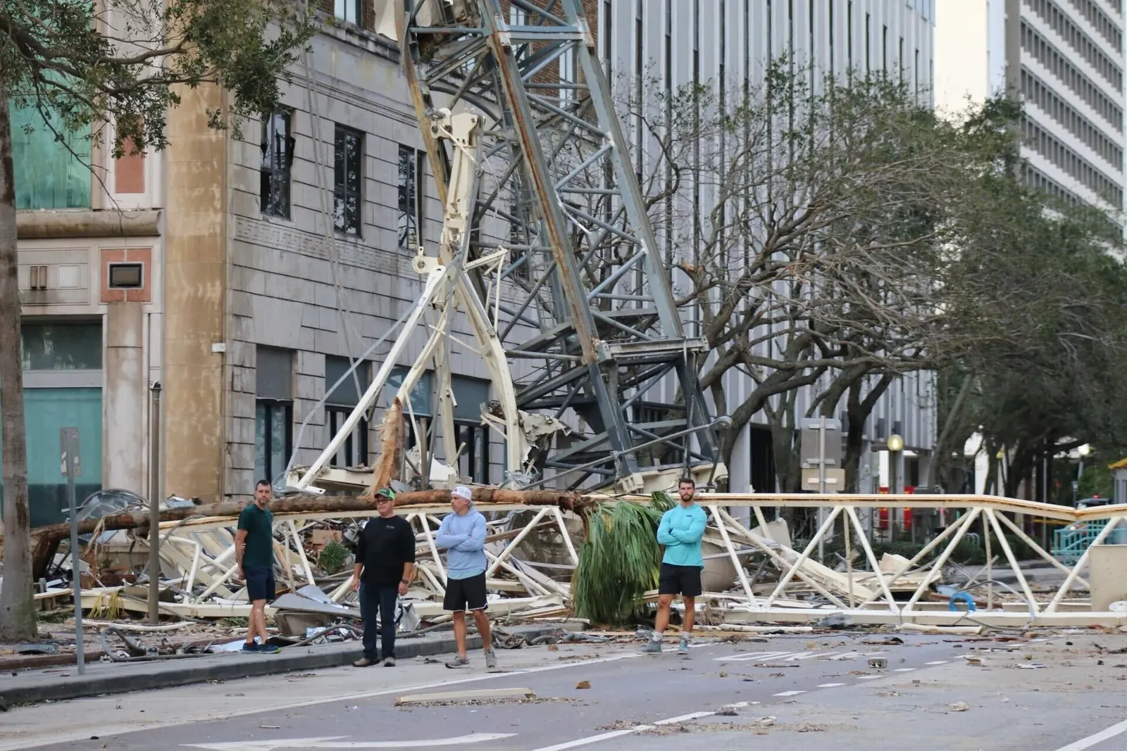 People on the ground near collapsed crane wreckage