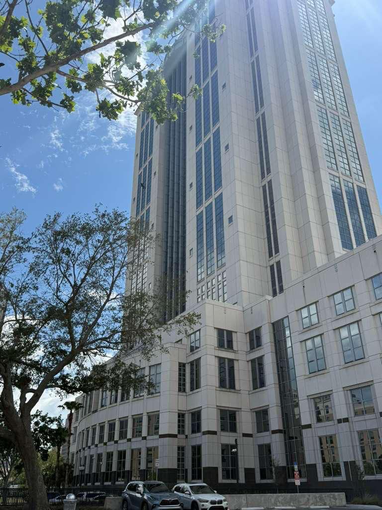 Rope-access window cleaner working the multi-story Orange County Government facade
